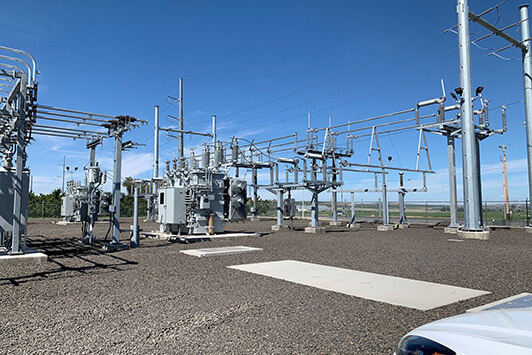 High-voltage electrical substation with transformers, lines, and switching equipment